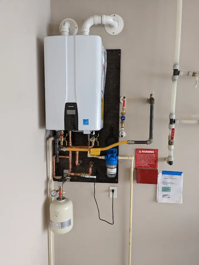 Professional plumber installing copper piping in a Triangle home