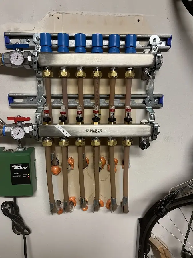 Plumber performing Water Heater Repair at a residential property in Triangle